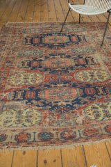 Aged fringe and geometric border in pomegranate red, navy blue, and ivory on the Soumac.