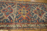 Antique Soumac runner end, displaying geometric patterns, vibrant gem tones, and visible foundation.