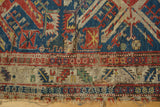 Antique Soumac rug detail: geometric patterns, jewel tones, visible tatter and exposed foundation.
