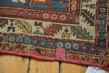 Antique Soumac rug detail showing geometric patterns, vivid gem-tone colors, and aged flatweave texture.