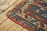 Antique Soumac rug border showing visible foundation, tattered edge, and pink binding.