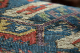 Antique Soumac flatweave pattern in vibrant blues, reds, and purple, revealing its foundation.