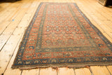 Antique Hamadan rug's terra cotta blush germinating flower field and tattered blue side.