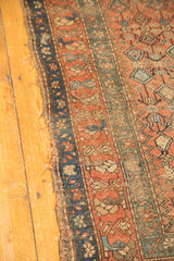 Antique Hamadan runner's side border, with visible tatter and terra cotta floral motifs.
