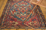 Vintage Lilihan rug: indigo field with red exaggerated floral palmettes and arabesques.