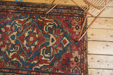 Vintage Lilihan rug detail with indigo, wine red floral palmettes and a time-softened patina.