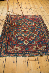Mostly secure fringe on a vintage Lilihan rug with indigo and wine red pattern.