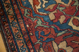 Vintage Lilihan rug detail showing multi-band border and rich indigo, wine red floral motifs.