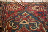Intricate indigo blue and wine red floral palmettes on a vintage Persian Lilihan rug.