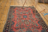 Vintage Lilihan rug's navy geometric border, cinnabar red field, light tatter.