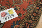 Detail of vintage Lilihan rug showing cinnabar field, powder blue and mallard green blossoms.