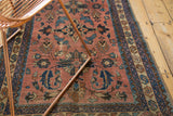 Antique Persian Lilihan rug detail: dusty rose field, scrolling leaves, blue and brown geometric borders.