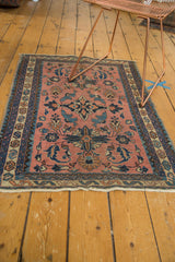 Persian Lilihan rug's lower edge with light foundation, traditional navy blue border, and rosy pile.