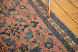Antique Lilihan rug corner with dusty rose field, serrated leaves, and navy, sky blue geometric border.