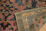 Antique Lilihan rug's dusty rose field, navy patterns, reverse foundation and machine binding detail.