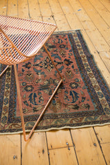 Antique Lilihan rug's lower edge: visible machine binding, dusty rose, and navy floral motifs.