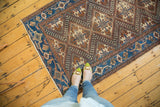 Unusual earthen bronze and watery blue coloration of a Kuba-inspired Hamadan rug pattern.