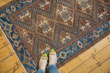 Wide watery blue border and geometric patterns of a vintage Caucasian style Hamadan rug.
