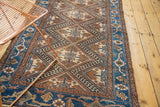 Vintage Caucasian Hamadan rug showcasing geometric diamond lattice and blue border patterns.