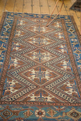 Intricate geometric diamond pattern on vintage Hamadan rug with earthen and watery blue tones.