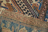 Hand-knotted vintage Hamadan rug's pile and woven foundation, with geometric patterns, tattered side.