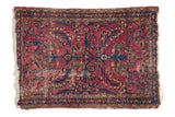 Vintage Lilihan rug, raspberry red field with allover navy and gold floral bouquet, decorative distress.