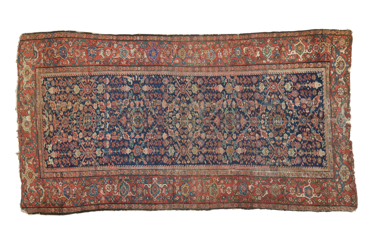 Antique Persian Fereghan rug with indigo blue floral lattice and a madder red Samovar border.