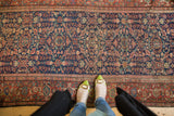 Antique Fereghan rug with indigo floral lattice field and classic Samovar border.