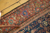 Antique Fereghan rug's Samovar border, intricate floral motifs in madder root red, indigo, and teal.