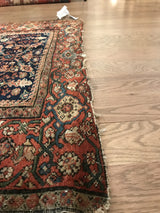 Delicate floral motifs and randomly colored Samovar border on this antique Fereghan rug's worn side.