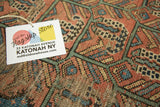Back of vintage Malayer rug, showing dense hand-knotted weave and store tag.