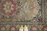 Lower border of antique Persian Isfahan rug with scrolling rococo, cochineal red and navy floral motifs.