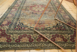 Cochineal red floral motifs and scrolling rococo borders on an antique Isfahan rug.