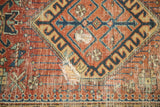 Interior hole and worn red geometric field of an antique Karaja runner.