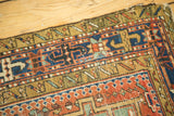 Antique Karaja runner detail: geometric hook and latch border with tattered edge and abrashes.