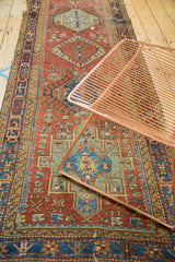Karaja runner's geometric medallion and hook motifs with abrashes in brick red and pale green.