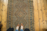 Vintage Afshar runner's central medallion motif and concentric diamond patterns in navy, gold, and ivory.