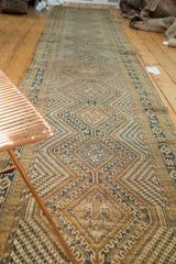 Geometric diamond pattern of vintage Afshar runner in navy, dusty gold, and soft brown.