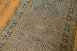Detailed concentric diamond motif and textured pile of the vintage Afshar runner.