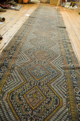 Vintage Afshar rug runner displaying intricate geometric diamond patterns in navy blue, gold, and ivory.