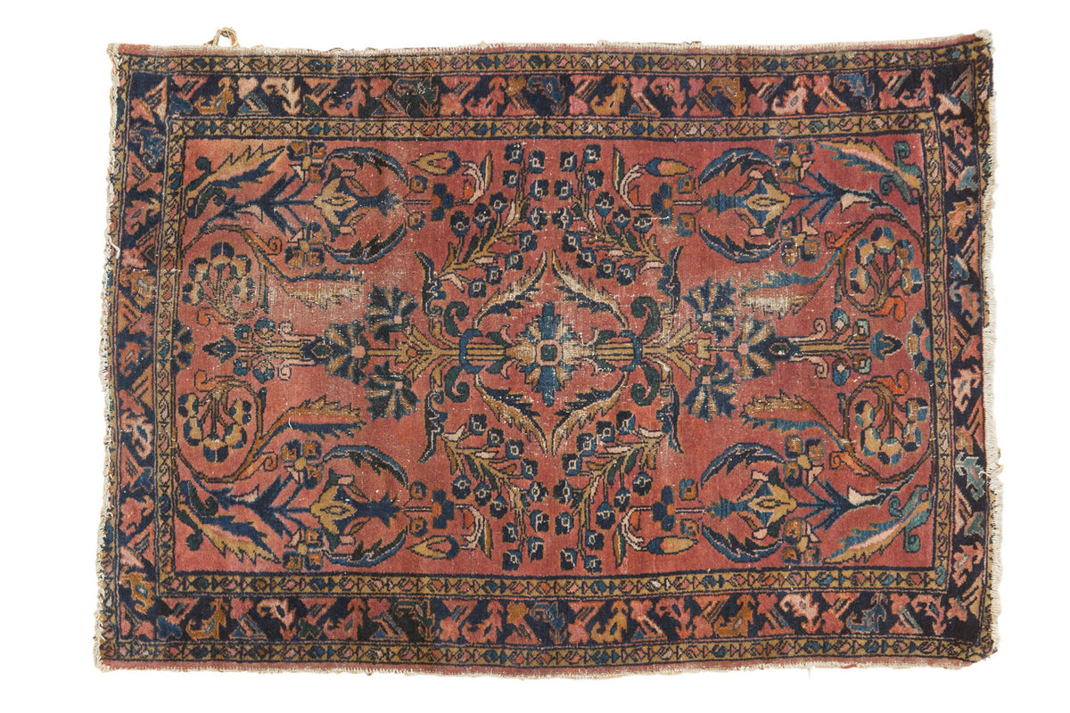 Vintage Persian Lilihan rug with ornate floral bouquets on a blush field, navy border.