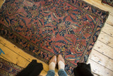 Vintage Lilihan rug, blush field with ornate floral design and patina. Feet for scale.