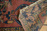 Vintage Lilihan rug reverse, revealing hand-knotted construction, classic design, and frayed fringe.