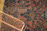 Ornate Lilihan rug detail showing expressive floral bouquets in blush, navy, and gold.