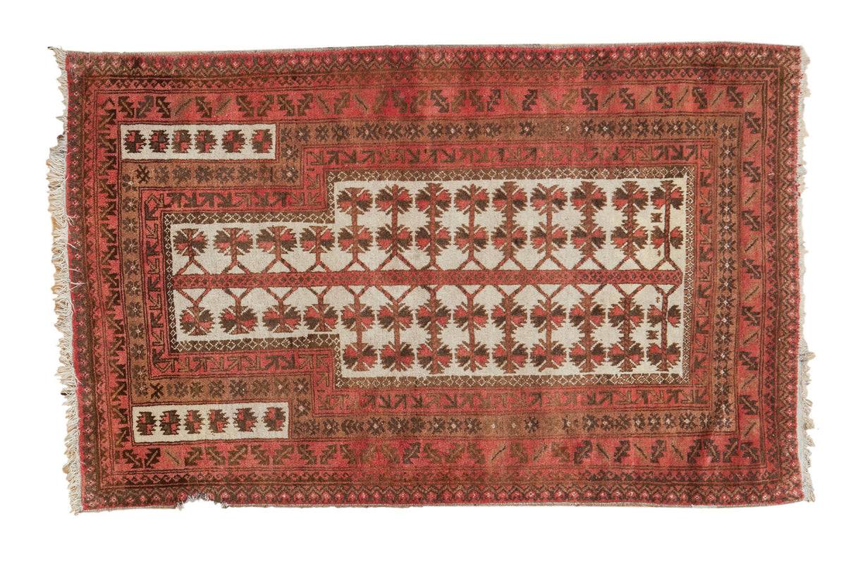 Vintage Turkmen prayer rug featuring a tree of life design in blush, bronze, and ivory.