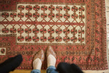 Vintage Turkmen rug, ivory field, blush and chocolate brown tree-of-life motifs.