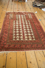 Vintage Turkmen rug's tattered ivory fringe and blush, bronze, brown patterned border.