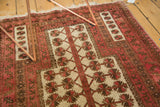 Glossy wool pile of a vintage Turkmen rug with blush, bronze, and ivory floral patterns.