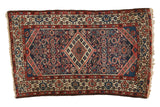 Vintage Borchalou rug with elongated diamond medallion, madder red, navy blue Herati pattern.
