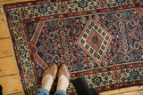Finely woven vintage Borchalou rug, central elongated diamond medallion, navy, madder red, and beige.